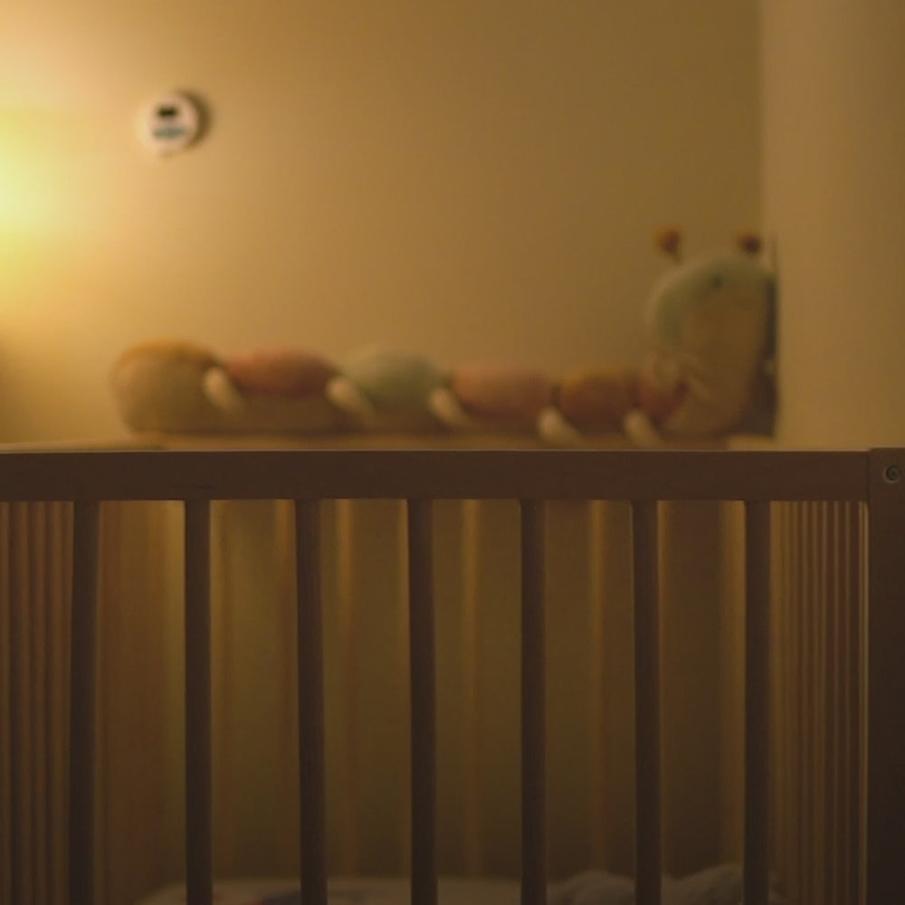 Cubtale Sleep Cub button by a crib, used to log baby sleep without opening your phone